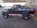 1994 Ford Bronco - This 1994 Ford Bronco is seen from the side, parked indoors with airplanes in the background.