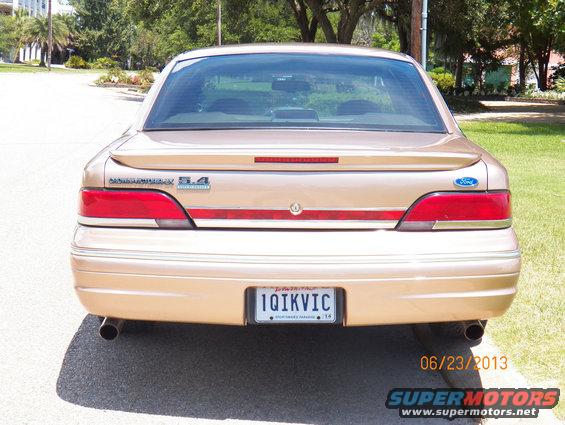 Gold 1993 Ford Crown Victoria rear view with spoiler and dual exhaust pipes