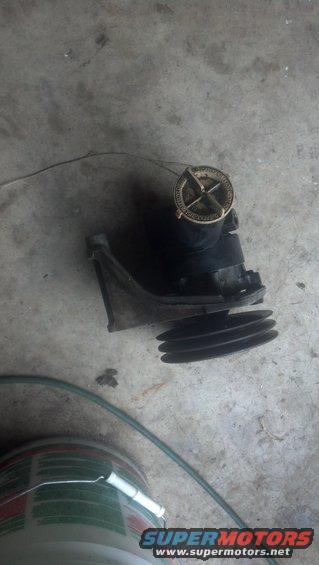 water pump pulley with a gold cap on top