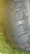 1983 Ford F-250 - The image shows a close-up of a tire's tread, with grass visible at the bottom and a watermark for Supermotors.net.