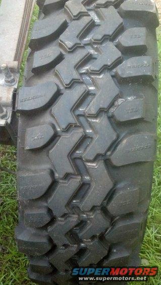 Close-up of a knobby off-road tire with visible sidewall text and tread pattern