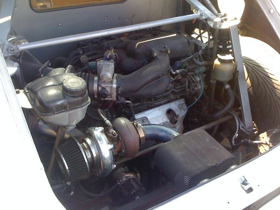 Turbocharged engine bay with custom intake and exhaust components
