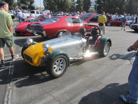 Silver and yellow open-top sports car with green fenders and number 6 on side