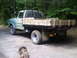 1979 Ford Bronco - This Ford F-Series truck, likely from the early 1970s, features a custom wooden flatbed and a protective rack over the bed.