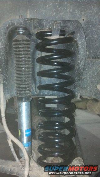 Suspension coil and shock absorber with blue Bilstein branding