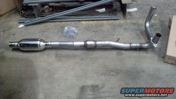 Exhaust pipe with muffler and catalytic converter on concrete floor