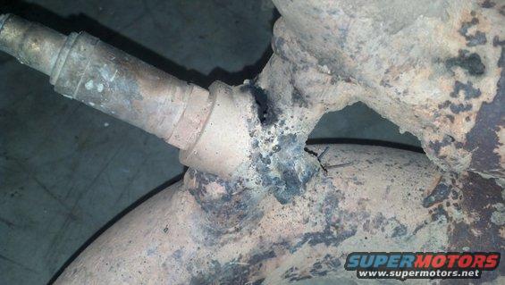 Exhaust pipe with a hole and visible weld damage