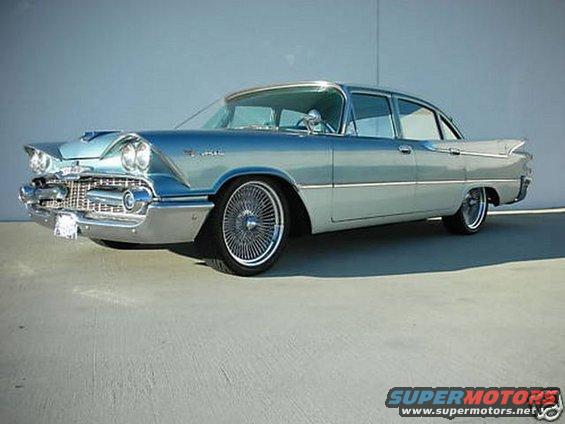 Light blue 1959 Dodge Custom Royal sedan with wire wheels parked outside