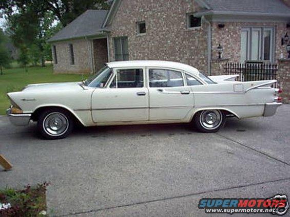 White 1959 Dodge sedan parked in driveway