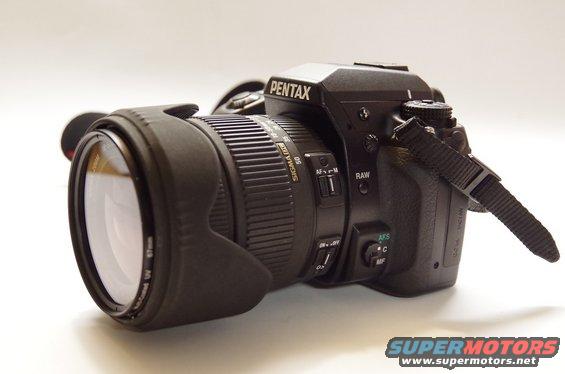 Pentax DSLR camera with a Sigma lens attached, shown from the side