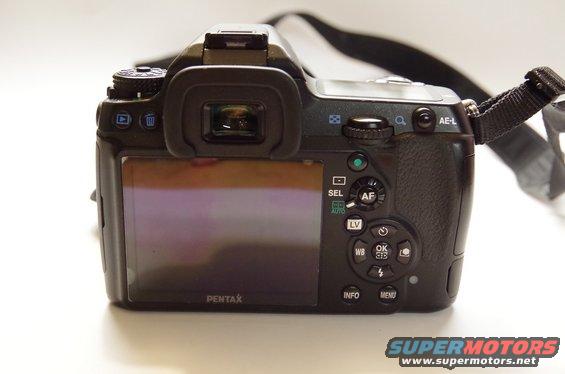 Black Pentax digital camera rear view with LCD screen and control buttons