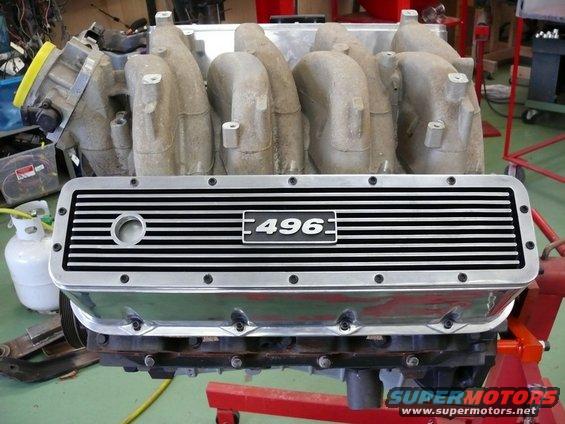 Chrome valve cover with "496" emblem on a V-shaped engine block