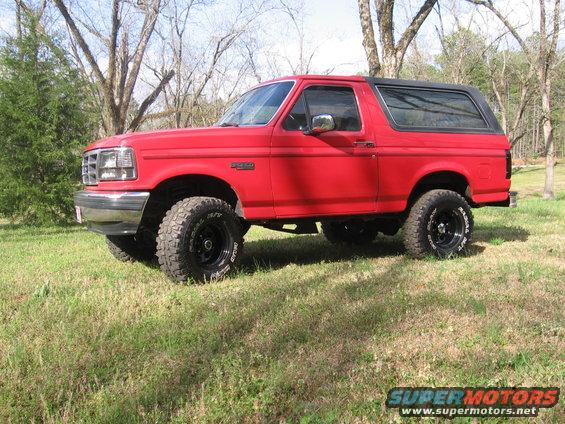 1992 Ford Bronco, red paint, black removable top, lifted suspension, aftermarket wheels and tires