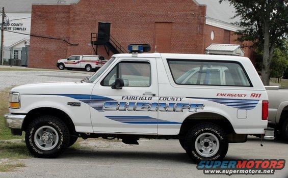 1992 Ford Bronco Sheriff SUV parked, with another vehicle behind it