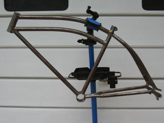 Rusty bicycle frame mounted on a blue stand