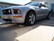 2006 Ford Mustang - Front 3/4 view of a silver 2006 Ford Mustang coupe parked in a driveway.