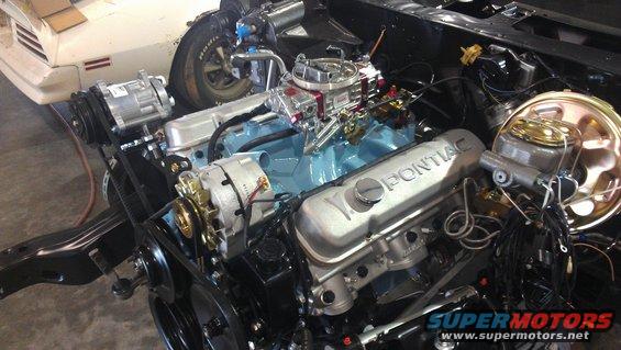 1972 Pontiac Trans Am engine with light blue block, silver valve covers, and chrome carburetor
