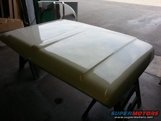 Light beige truck hood on sawhorses, showing a central raised ridge and curved edges