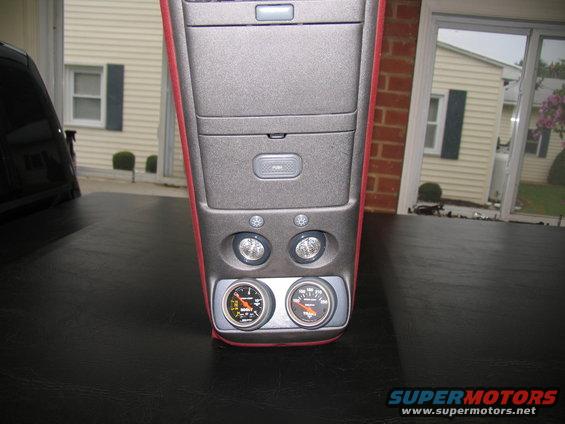 Center console with two gauges and a push button