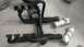 1990 WetJet Duo - Two sets of exhaust headers and mufflers are laid out on a concrete floor, with some components wrapped in paper.
