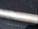 1999 Mercury Grand Marquis - A close-up shows an exhaust pipe with faint markings, placed on a textured metal surface.