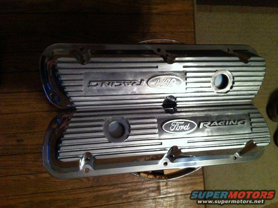 Two chrome Ford Racing valve covers with ribbed detail and Ford oval logos