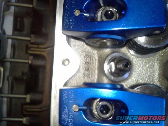 Blue roller rocker arms on engine block with casting number X302