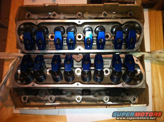 Pair of Ford engine cylinder heads with blue roller rockers