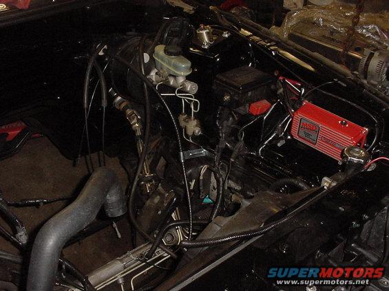Engine bay showing brake fluid reservoir, wiring, and a red MSD ignition control box