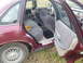 1992 Ford Crown Victoria - The interior of a maroon 1992 Ford Crown Victoria is visible, with a hamburger resting on the back seat.