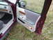 1992 Ford Crown Victoria - The interior door panel of a car, fabric upholstery and wood accents, is shown with the door ajar.