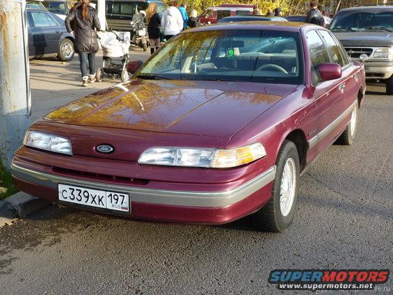 Maroon 1992 Ford Crown Victoria, front view, with chrome trim and a Russian license plate