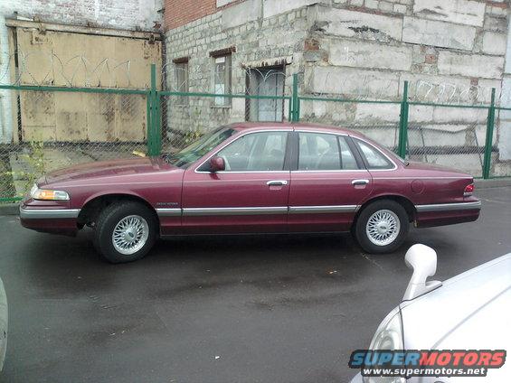1992 Ford Crown Victoria sedan, side view. Another car is partially visible in the foreground