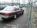 1992 Ford Crown Victoria - A maroon 1992 Ford Crown Victoria is parked next to a chain-link fence.