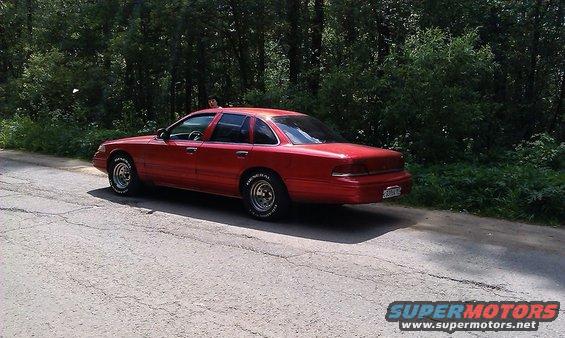 Red 1992 Ford Crown Victoria, rear 3/4 view