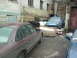 1992 Ford Crown Victoria - A maroon 1992 Ford Crown Victoria is parked in a yard with several other vehicle parts and bodies visible.