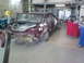 1992 Ford Crown Victoria - Car in a workshop, possibly undergoing restoration or repair work. Trunk is open and interior is exposed.