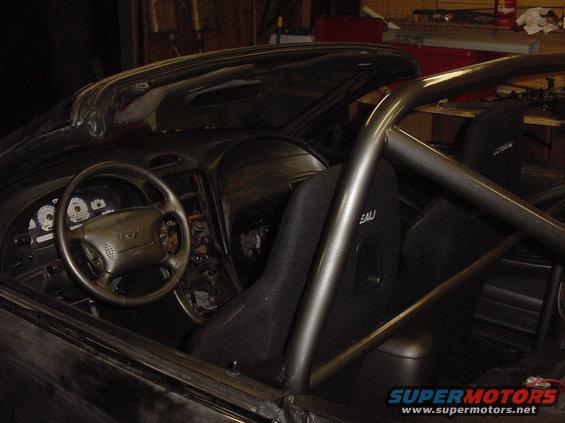1995 Ford Mustang interior with roll cage and racing seats