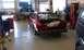 1992 Ford Crown Victoria - Red sedan in a garage with its trunk open. Another vehicle is visible on a lift.
