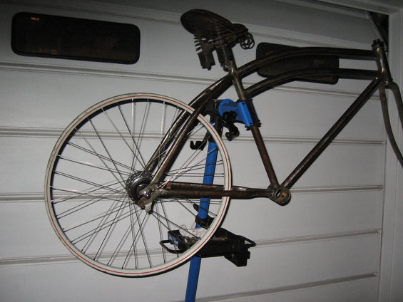 bicycle frame on stand, showing rear wheel and saddle