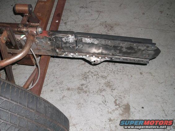 Welded car frame section with tire in foreground