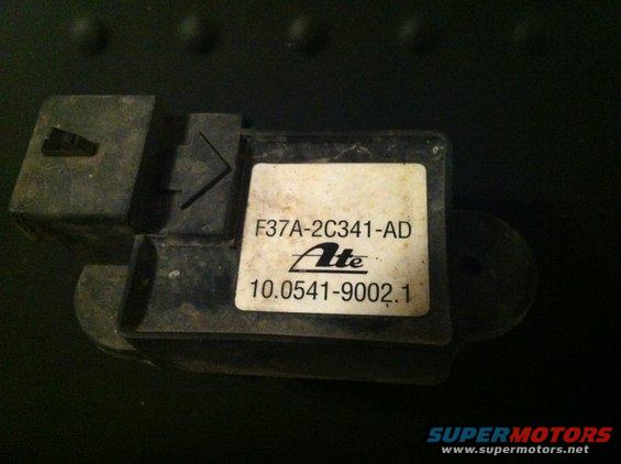 Close-up of a black automotive sensor with a white label showing part numbers F37A-2C341-AD and 10.0541-9002.1, and the Ate logo