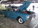 1963 Ford Ranchero - A blue 1963 Ford Ranchero is displayed with its hood open, showing the engine and a "For Sale" sign.