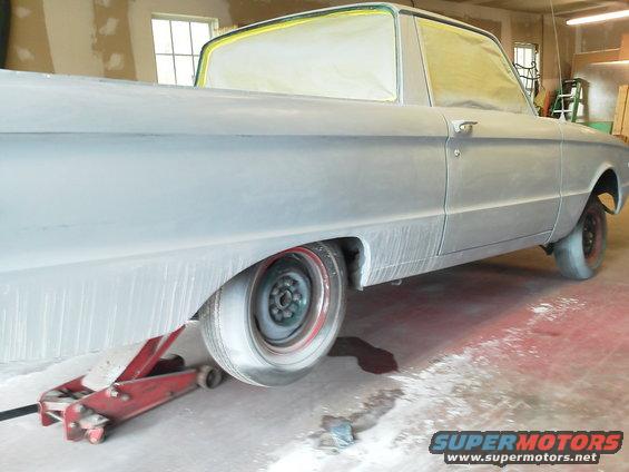 1963 Ford Ranchero side view, undergoing bodywork with primer and masking tape on windows