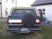 1991 Ford Bronco - The rear of a Ford Bronco shows a two-tone paint scheme and a spare tire mounted externally.