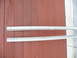 1993 Mazda MX-3 - Two white side skirts are shown against a red wooden wall, likely for a vehicle.