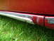 1993 Mazda MX-3 - The side skirt trim on this vehicle shows signs of wear and tear with chipped paint.