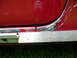 1993 Mazda MX-3 - The edge of a red car door shows damage and rust, with a ruler placed to measure the extent of the corrosion.