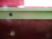 1993 Mazda MX-3 - Close-up view of a side skirt attachment on a red vehicle.