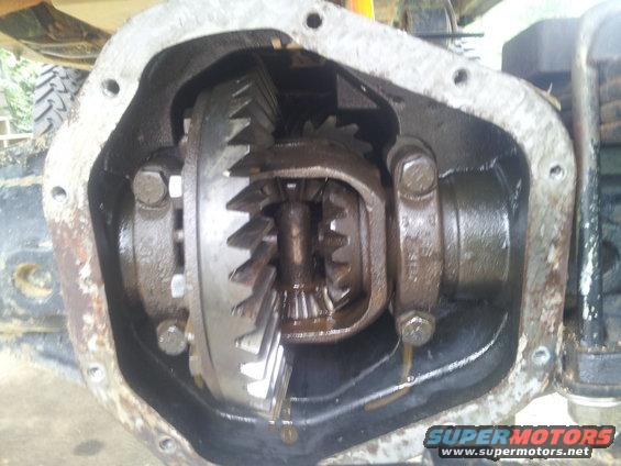 Close-up of an open differential with gears visible. Some oil is dripping